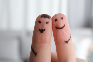 Photo of Two fingers with drawings of happy faces on blurred background. Spending time together