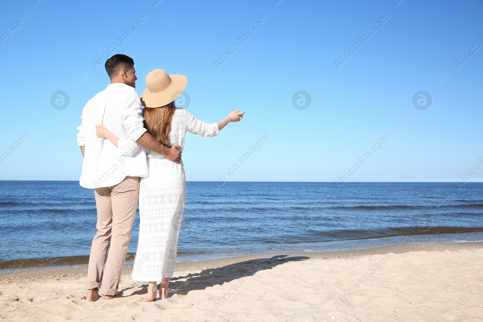 Photo of Lovely couple on beach. Space for text