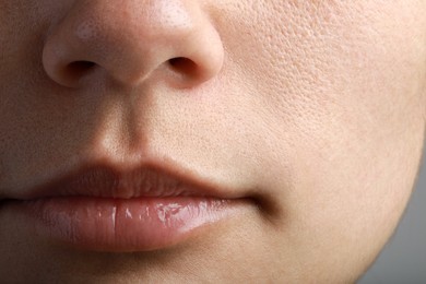 Closeup view of woman with healthy skin on light grey background