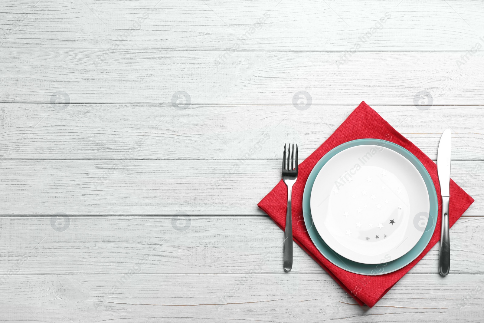 Photo of Patriotic table setting with traditional USA colors on wooden background, top view. Space for text