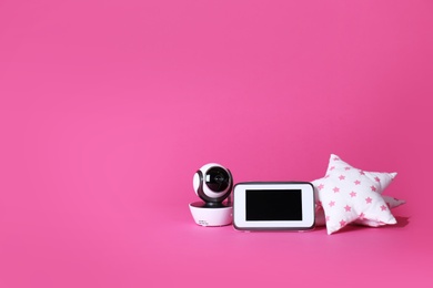 Modern CCTV security camera, monitor and soft toy on color background. Space for text