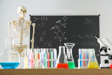 Different chemistry glassware and skeleton in classroom