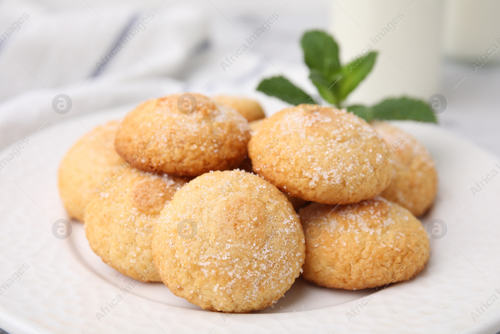 Photo of Tasty sweet sugar cookies and mint on table, closeup