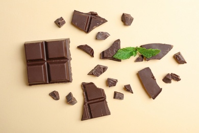 Photo of Flat lay composition with chocolate and mint on color background