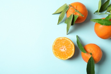 Flat lay composition with ripe tangerines on color background. Space for text