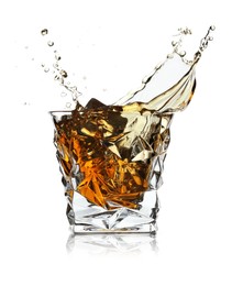 Photo of Whiskey splashing in glass isolated on white