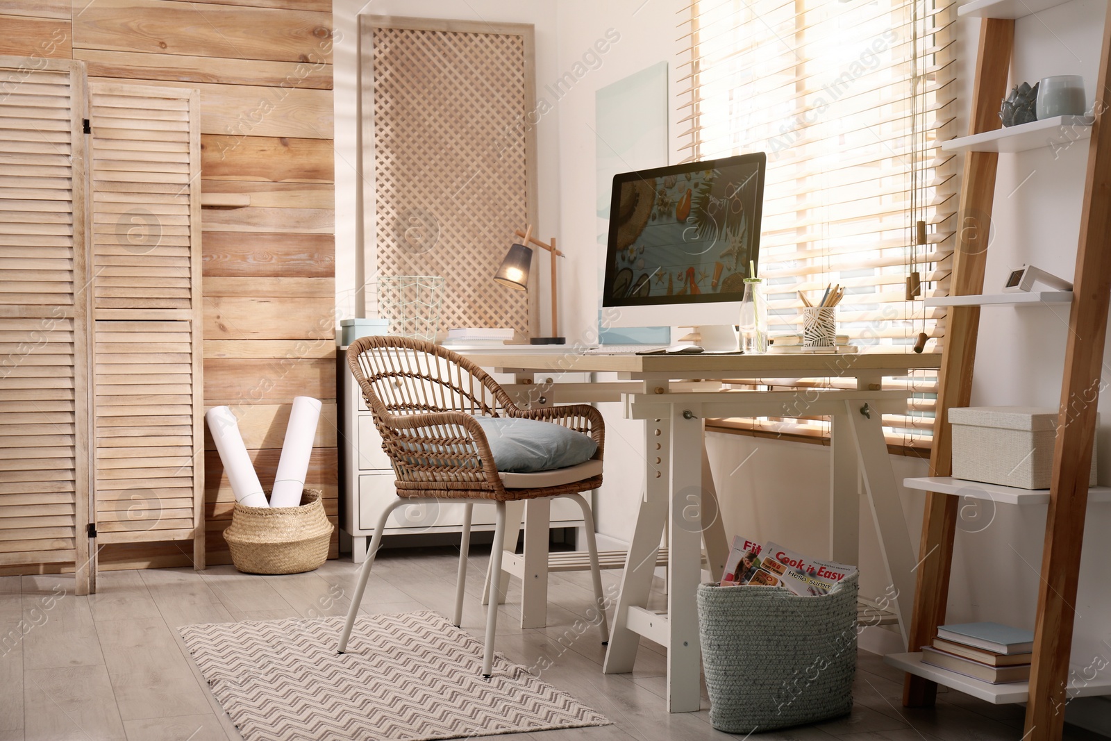 Photo of Comfortable workplace with modern computer near window. Interior design