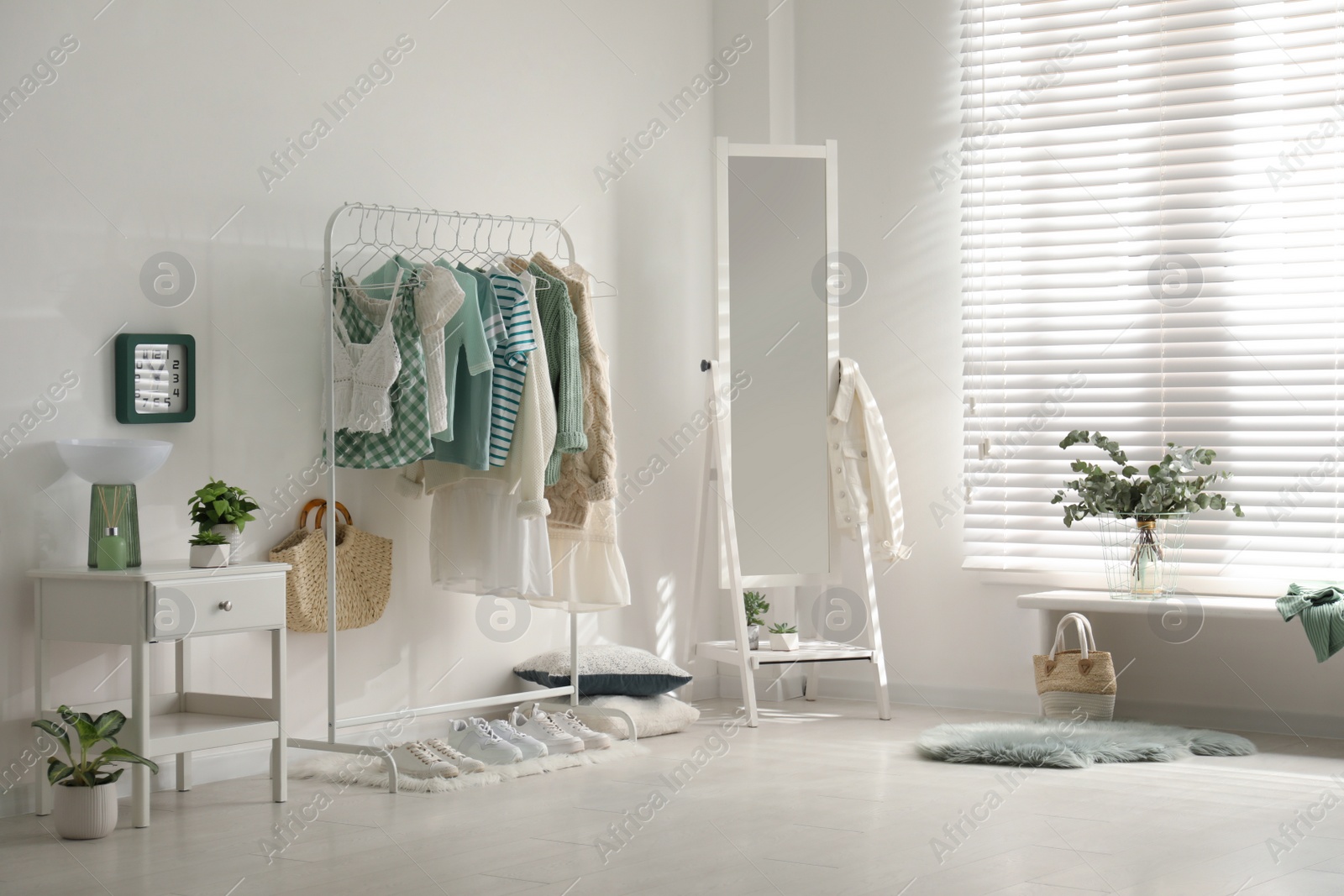 Photo of Dressing room interior with clothing rack and mirror