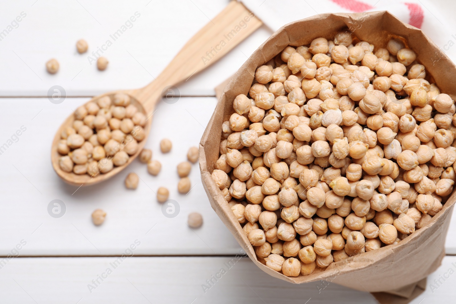 Photo of Chickpeas on white wooden table, flat lay. Space for text