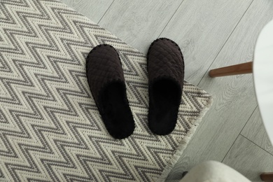 Soft men's slippers on floor, flat lay