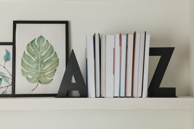 Bookends with books and pictures on shelf indoors