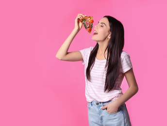 Beautiful woman with pizza on pink background, space for text