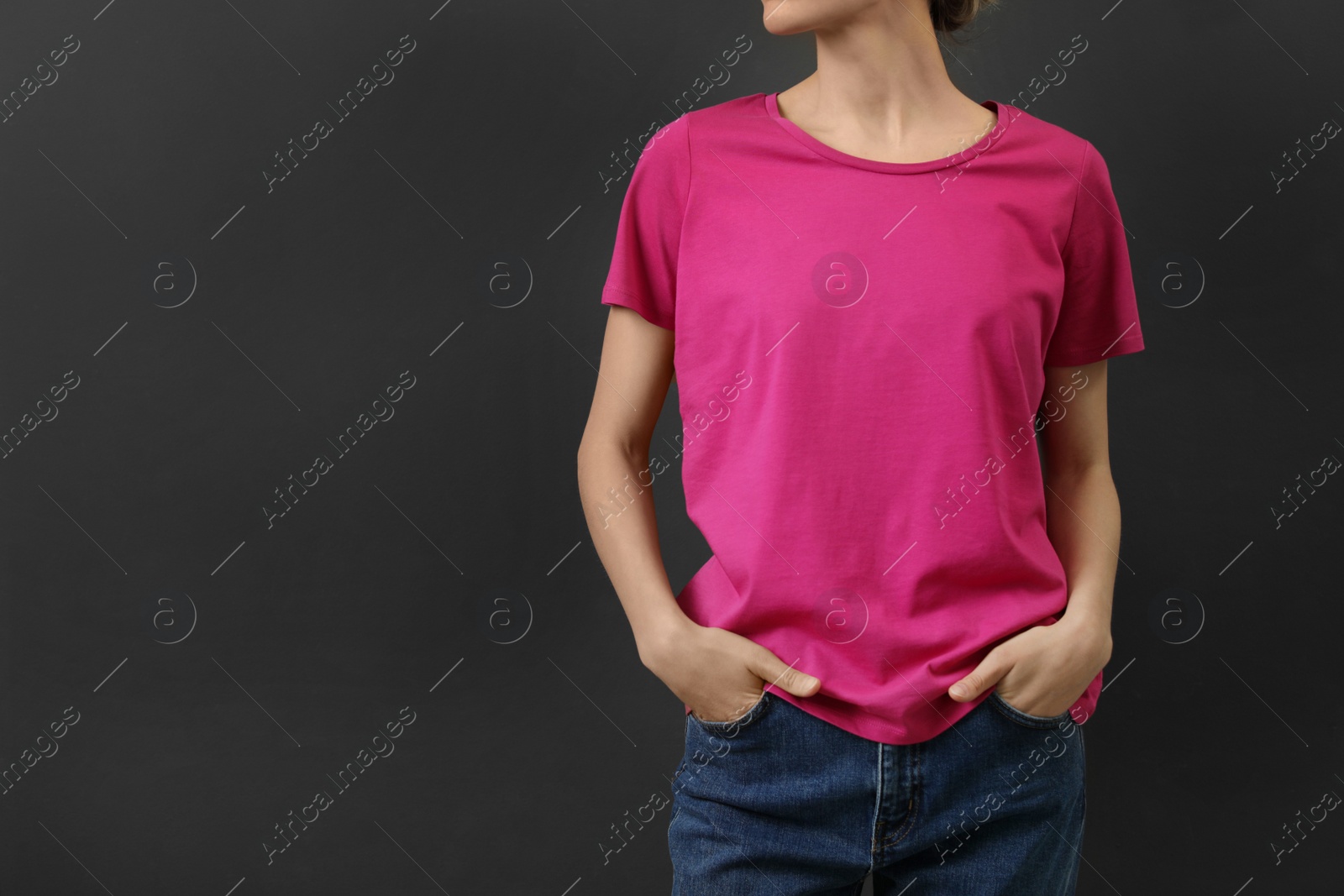 Photo of Woman in bright t-shirt on dark background. Mock up for design