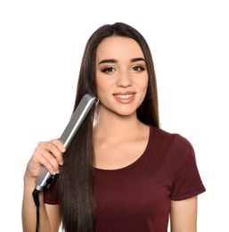 Happy woman using hair iron on white background