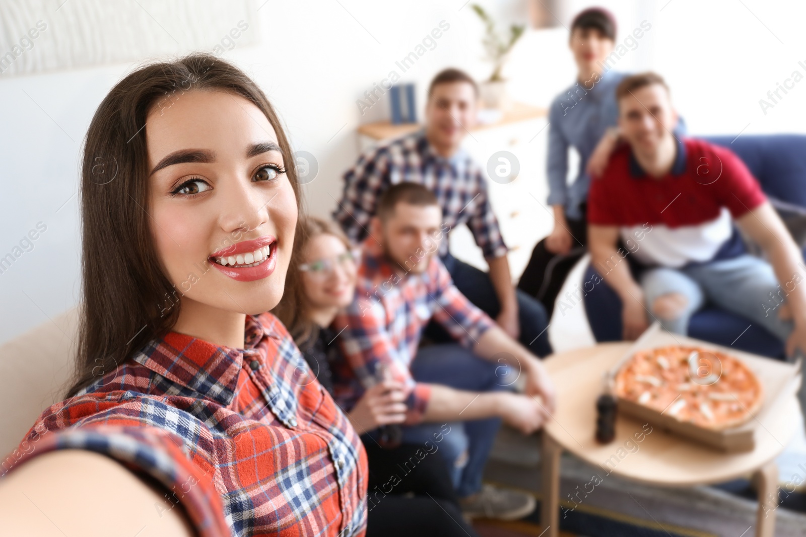 Photo of Happy friends taking selfie indoors