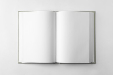 Photo of Open book on white background, top view