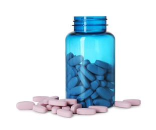 Photo of Bottle and pile of vitamin pills isolated on white