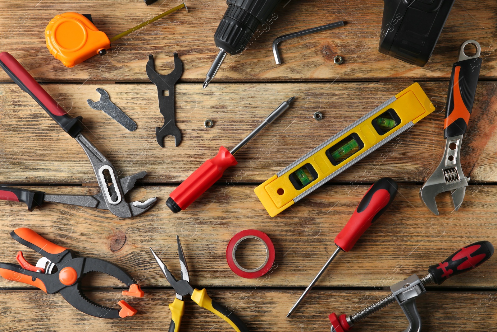 Photo of Set of repair tools on wooden background, flat lay