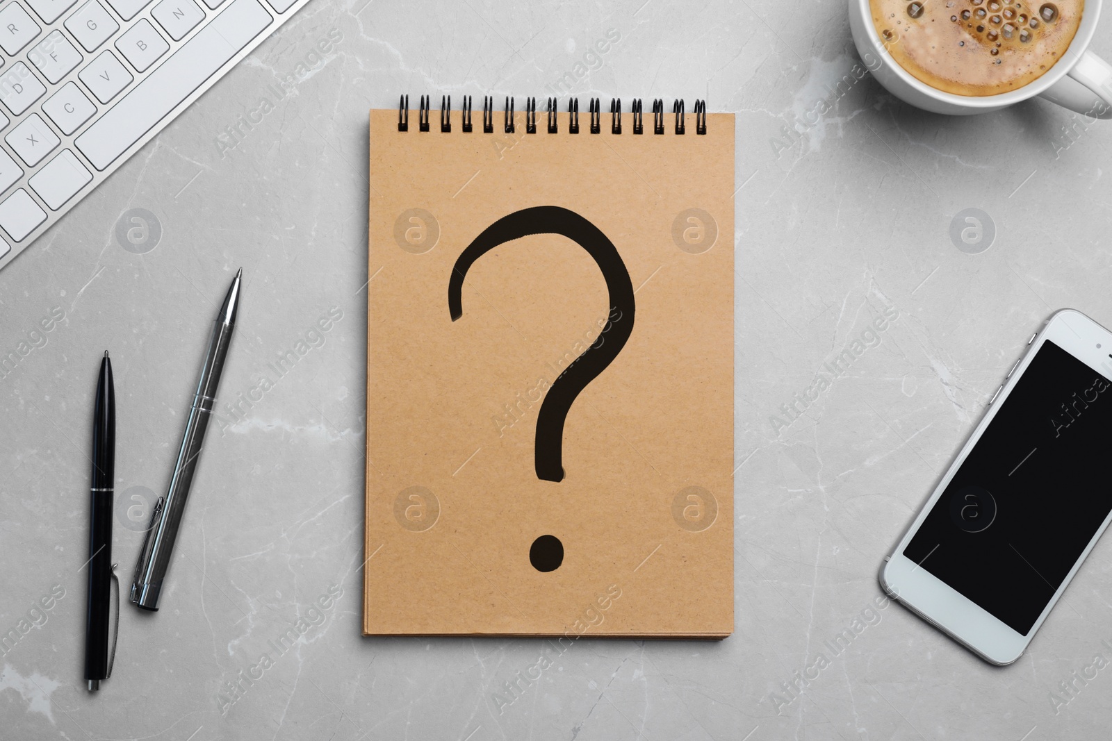 Image of Flat lay composition of smartphone, pens and notebook with question mark on grey background