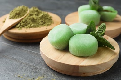 Photo of Delicious matcha mochi on grey table, space for text