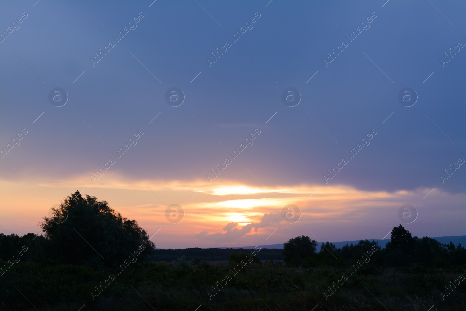 Photo of Picturesque view of countryside and beautiful sky at sunset