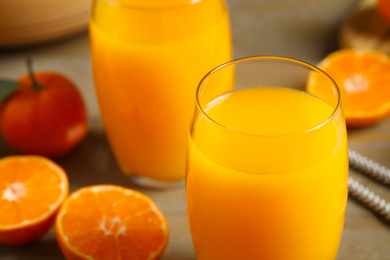 Photo of Glass of fresh tangerine juice, closeup view