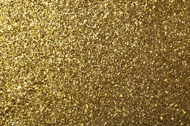 Beautiful shiny golden glitter as background, closeup