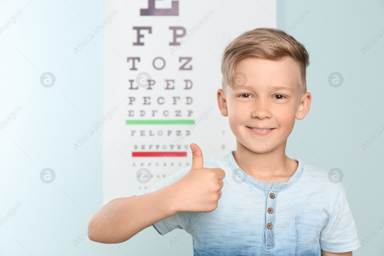 Photo of Cute little boy in ophthalmologist office