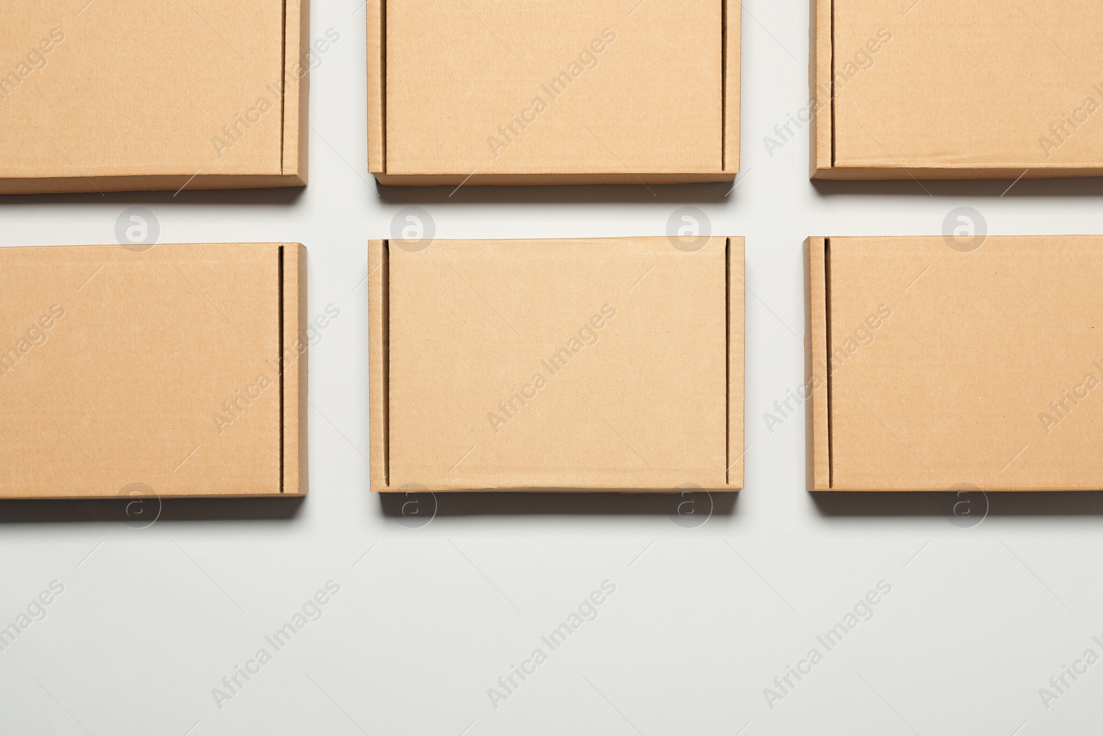 Photo of Many cardboard boxes on white background, flat lay. Packaging goods