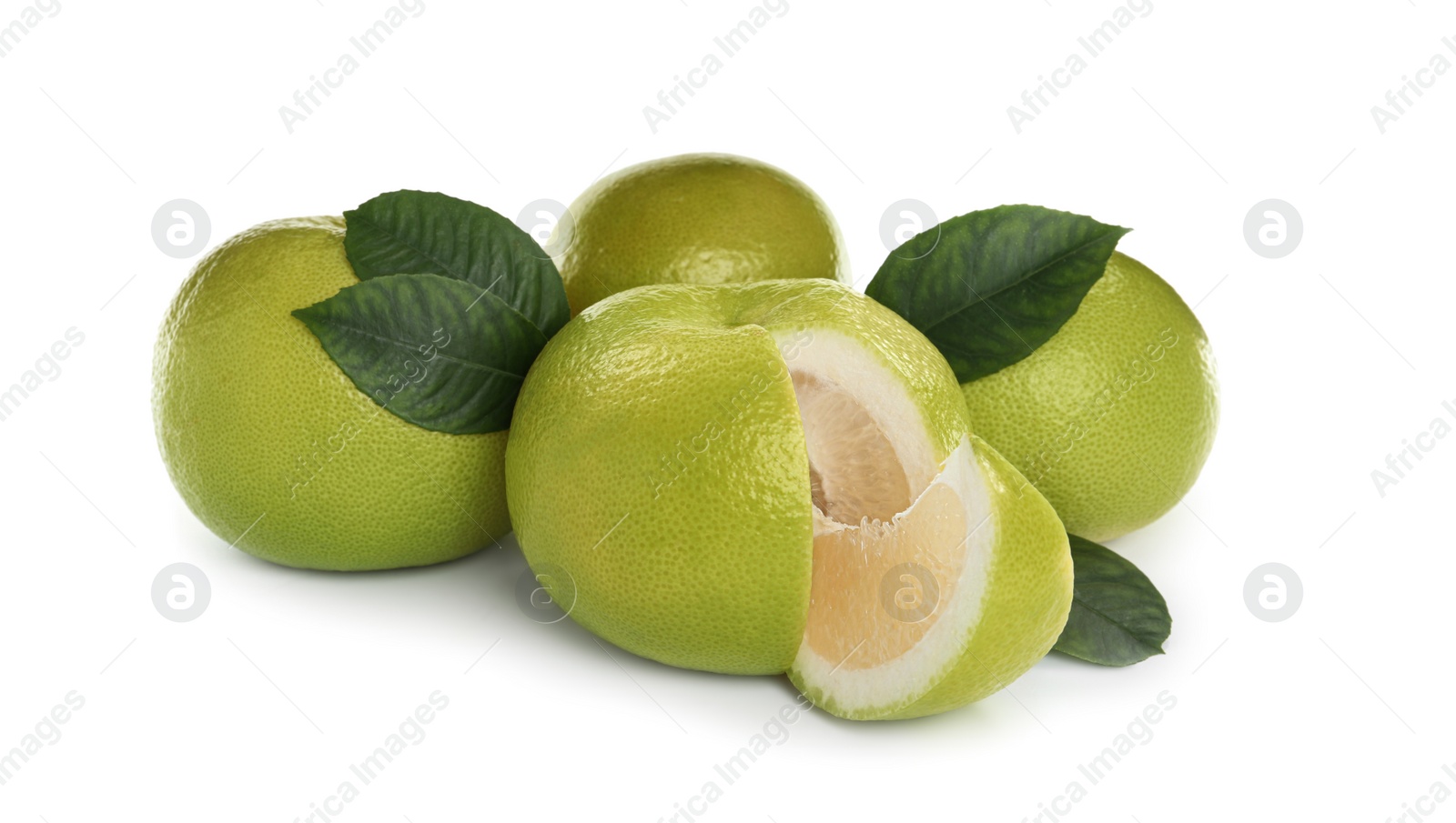 Photo of Whole and cut sweetie fruits with green leaves on white background