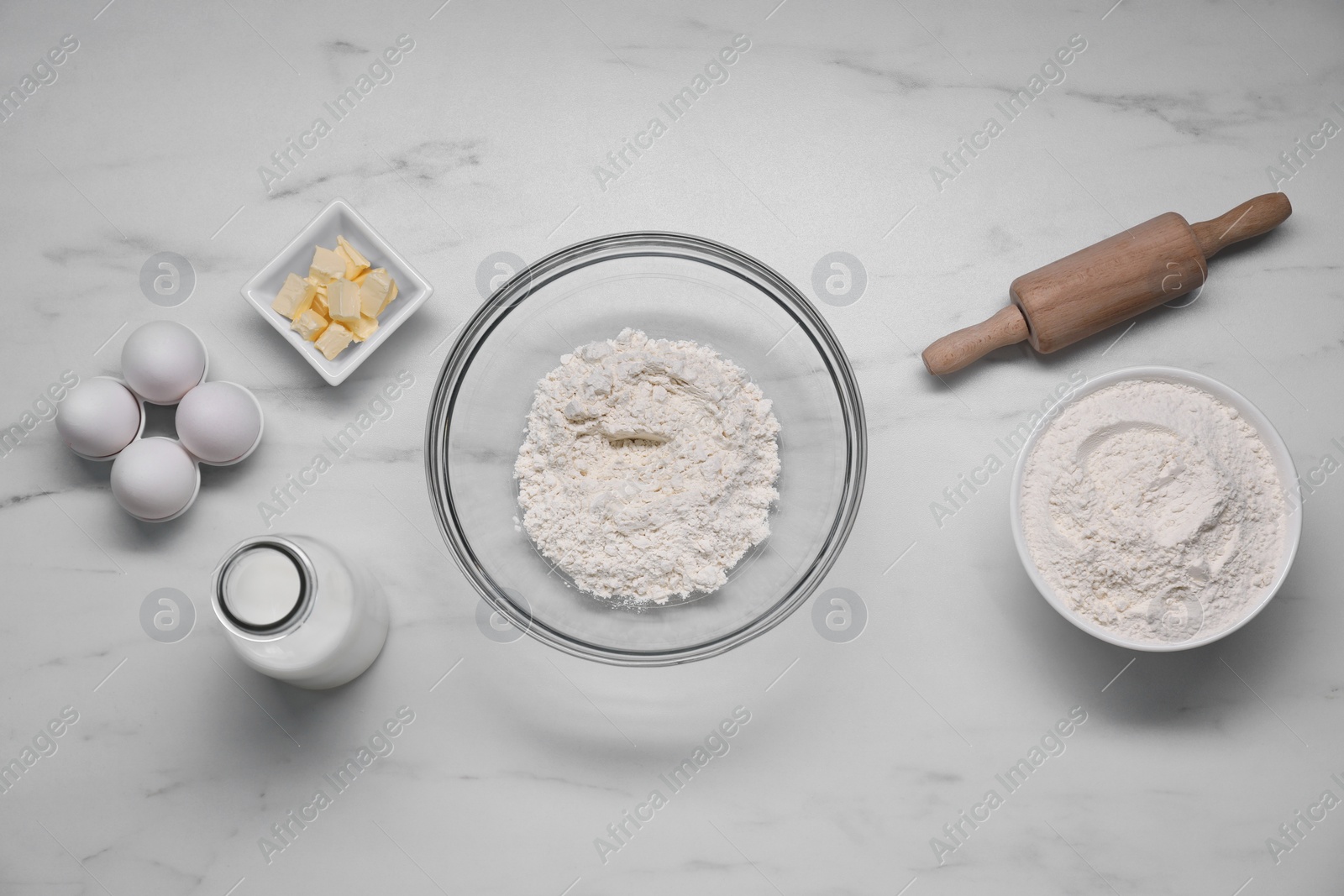 Photo of Different ingredients for making tasty baklava on white marble table, flat lay