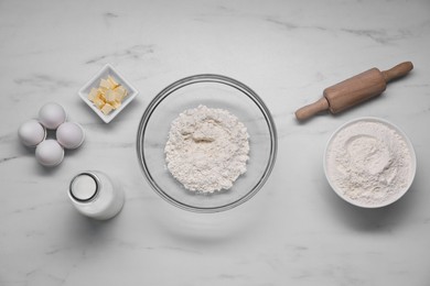 Different ingredients for making tasty baklava on white marble table, flat lay