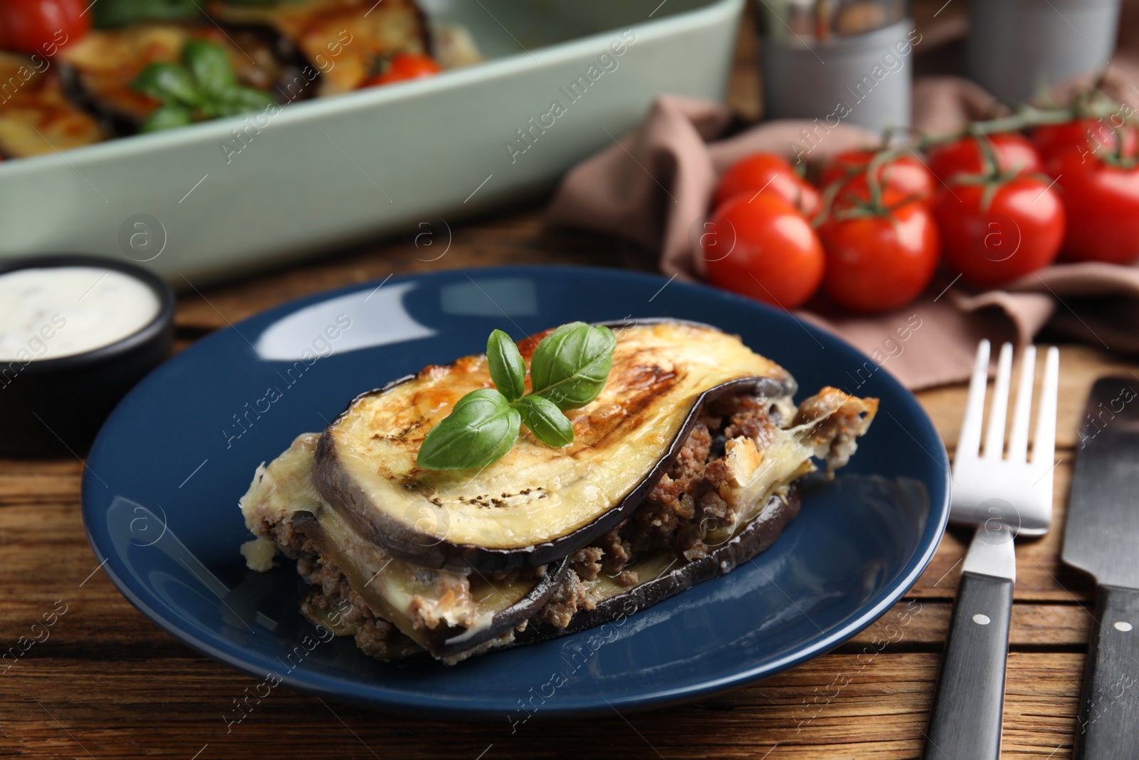 Photo of Delicious eggplant lasagna served on wooden table