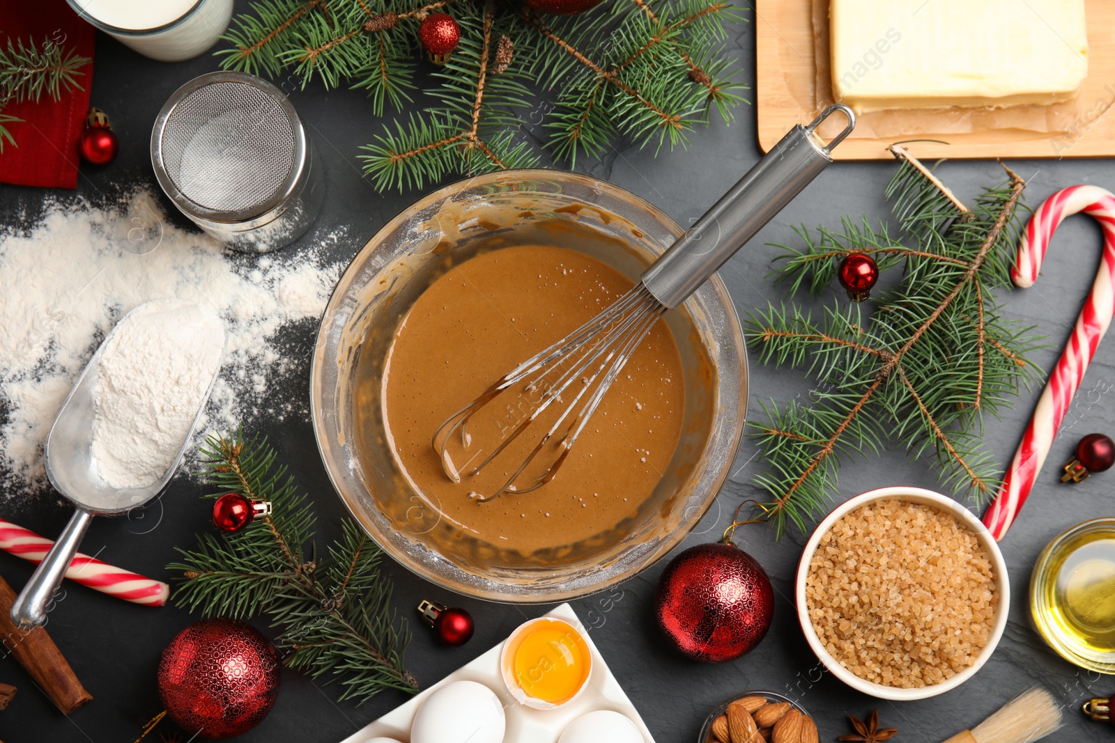 Photo of Flat lay composition with ingredients for traditional Christmas cake on grey table