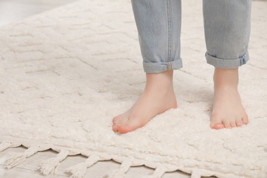 Photo of Woman standing on beige carpet, closeup. Space for text