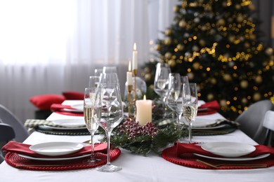 Christmas table setting with festive decor and dishware indoors