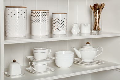 White shelving unit with set of dishware