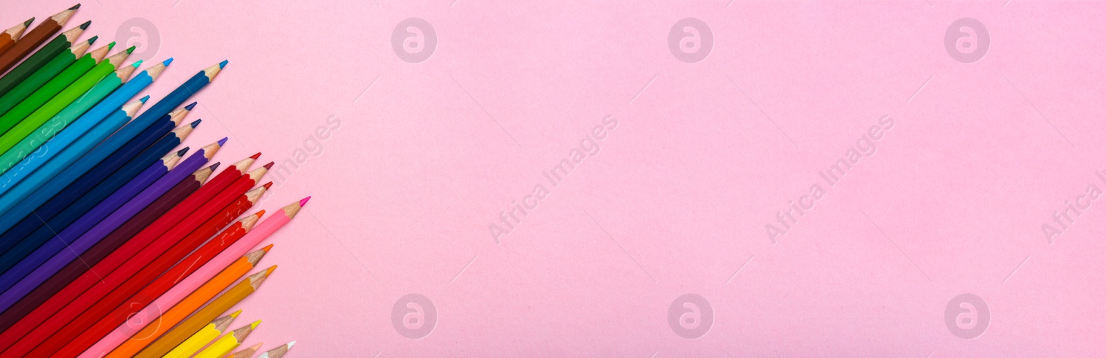 Image of Color pencils on pink background, flat lay with space for text. Banner design