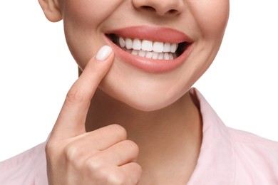 Woman showing her clean teeth and smiling on white background, closeup