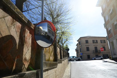 Photo of Traffic mirror on city street, space for text
