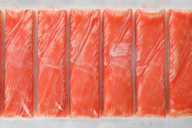 Top view on fresh crab sticks in pack as background, closeup