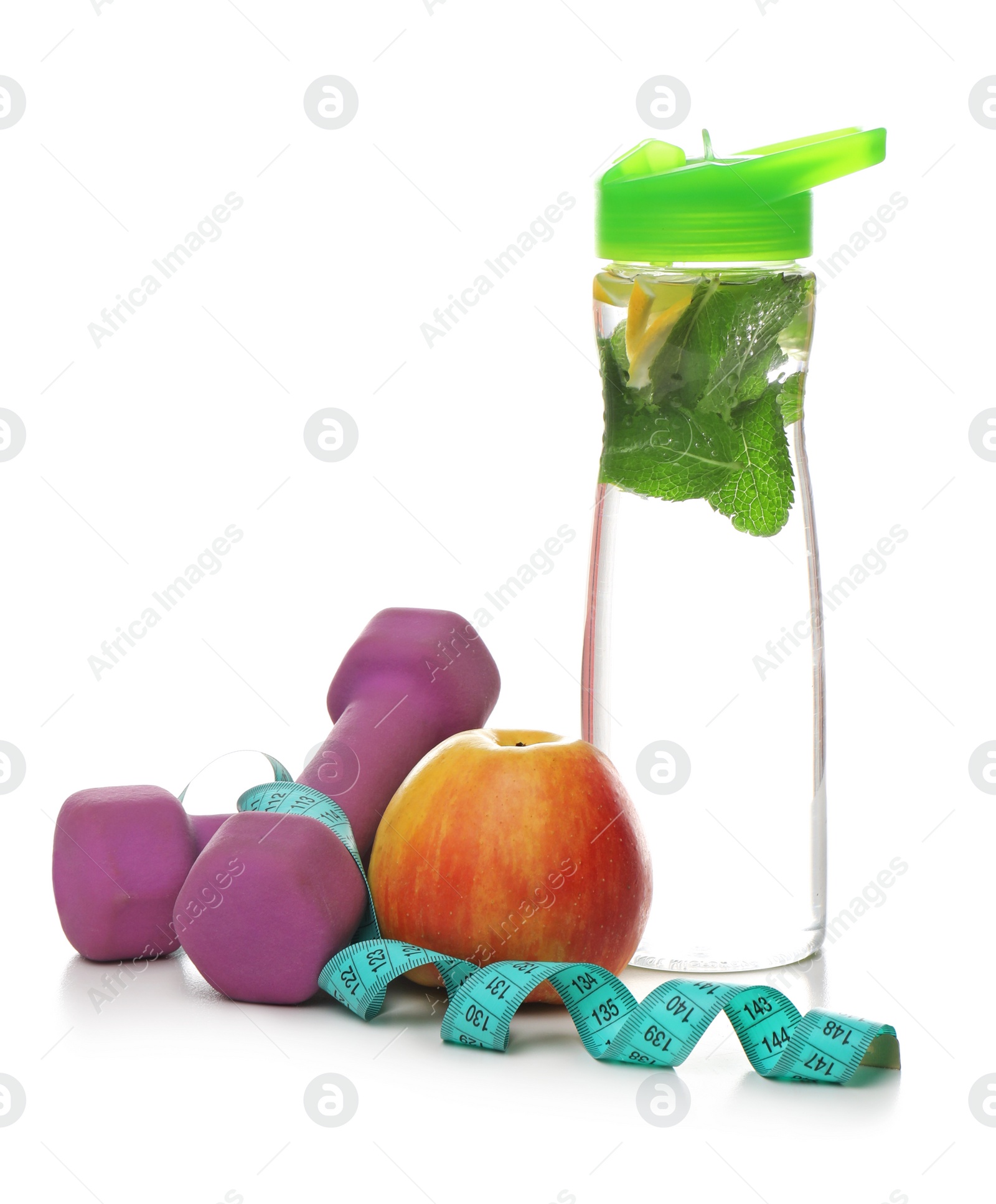 Photo of Tasty apple, measuring tape, dumbbells and bottle of water on white background. Healthy diet