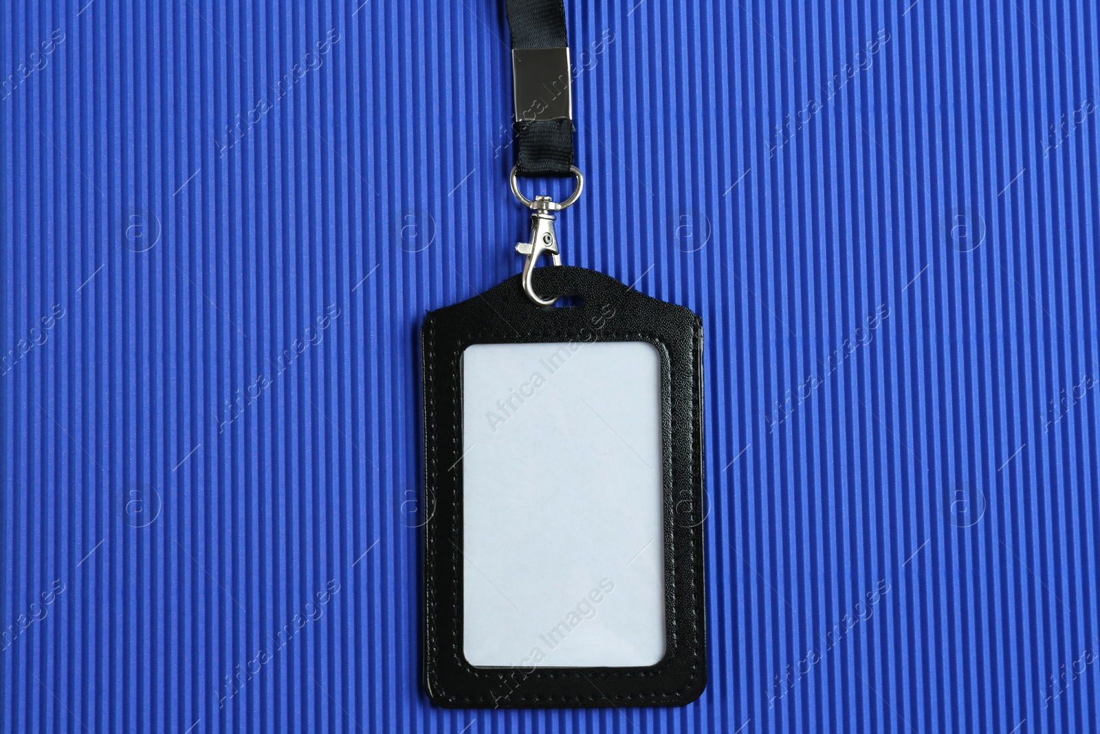 Photo of Blank badge on blue background, top view. Mockup for design