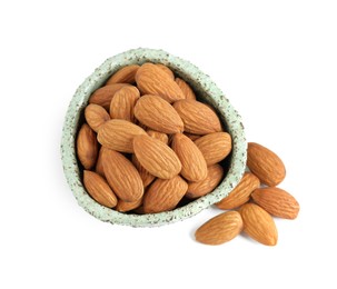 Photo of Bowl and organic almond nuts on white background, top view. Healthy snack