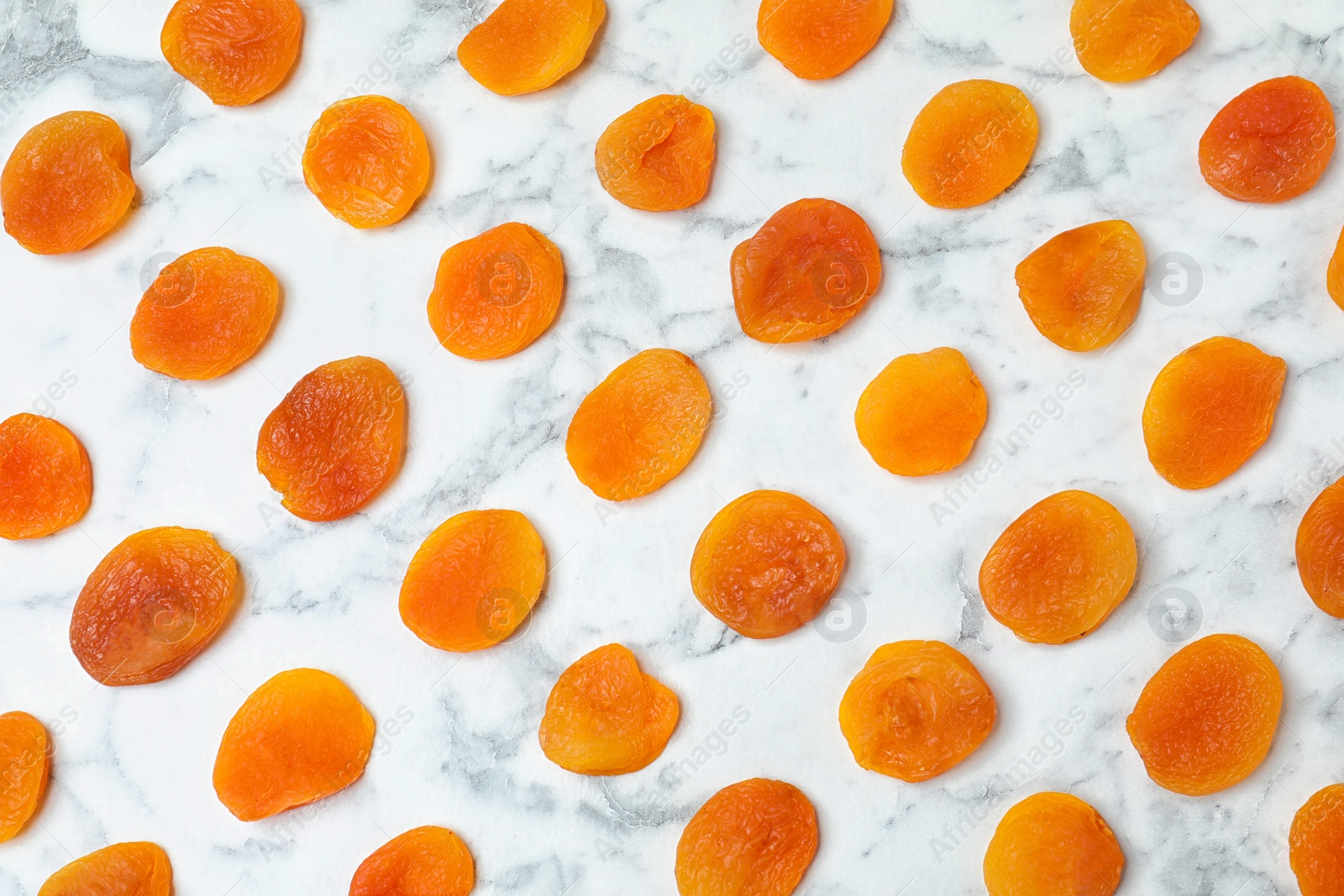 Photo of Flat lay composition with apricots on marble background. Dried fruit as healthy food