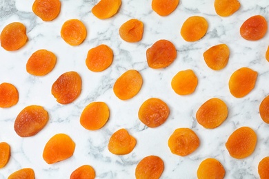 Flat lay composition with apricots on marble background. Dried fruit as healthy food