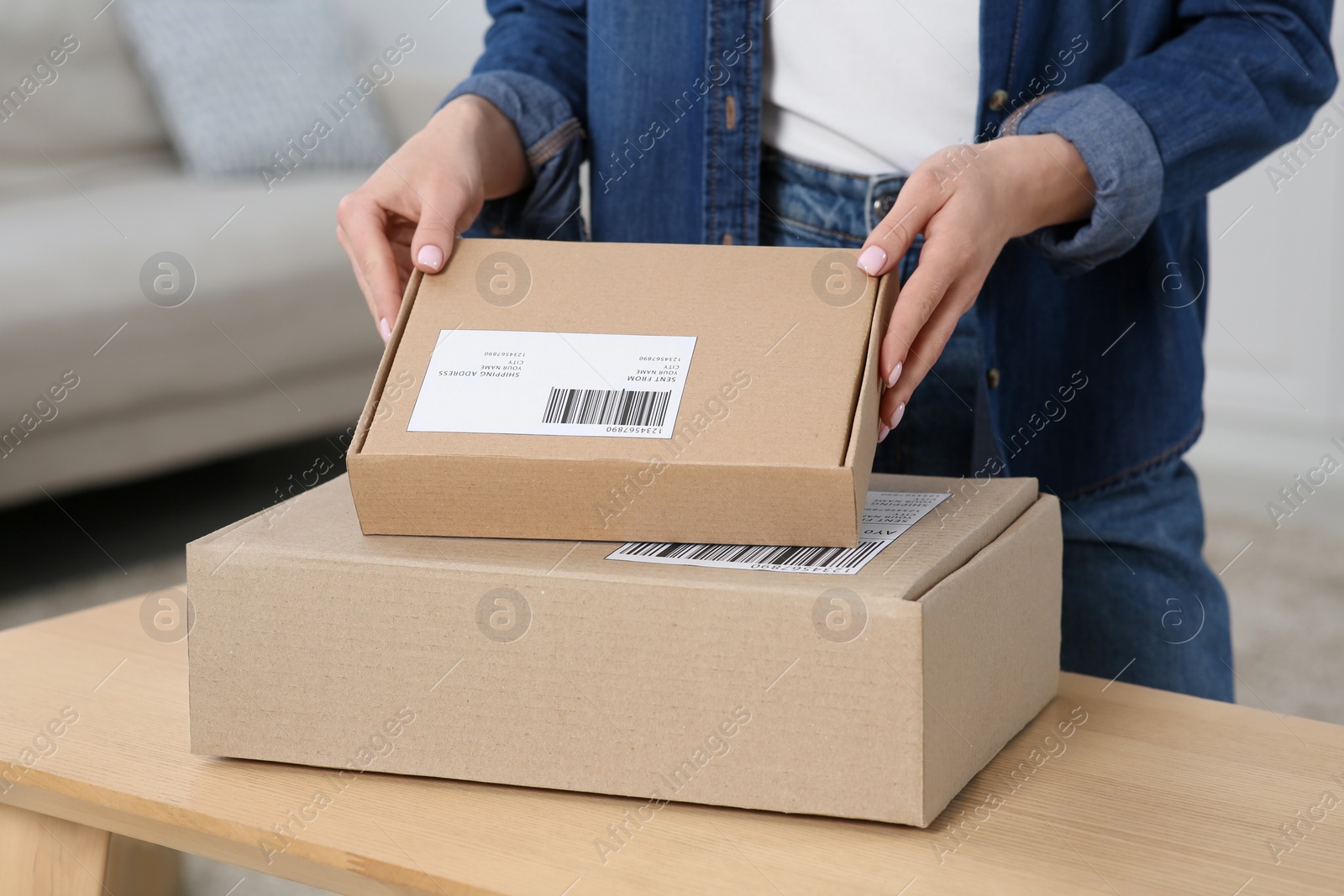 Photo of Woman unpacking parcel at home, closeup. Online store