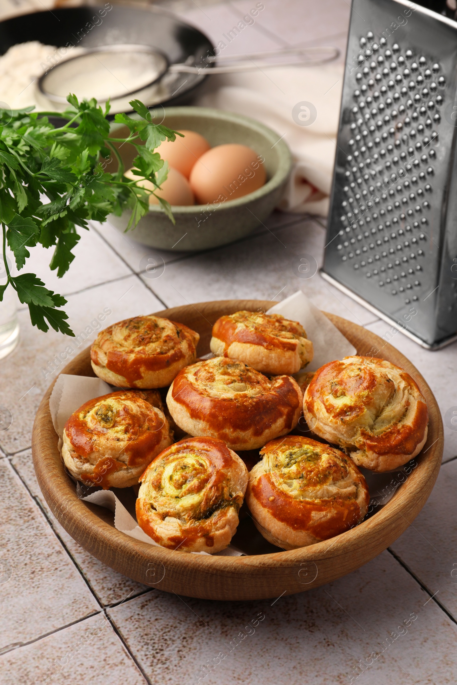 Photo of Fresh delicious puff pastry and ingredients on white tiled surface