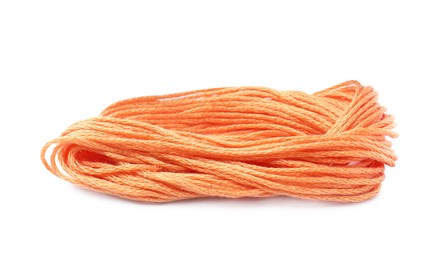 Photo of Pale orange embroidery thread on white background