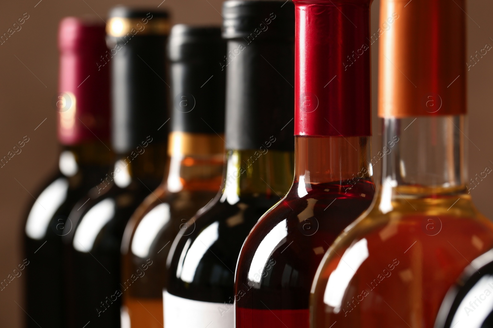 Photo of Bottles of different wines, closeup. Expensive collection